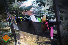 Black car organizer hanging from a vehicle's rearview mirror with various items.
