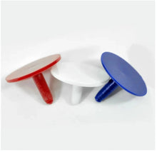 Three plastic GOLF BALL MARKERS in red, white, and blue on a white background