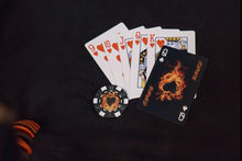 Playing cards and poker chips on a dark surface