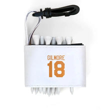 Golf tee holder with 'GILMORE 18' text on a white background