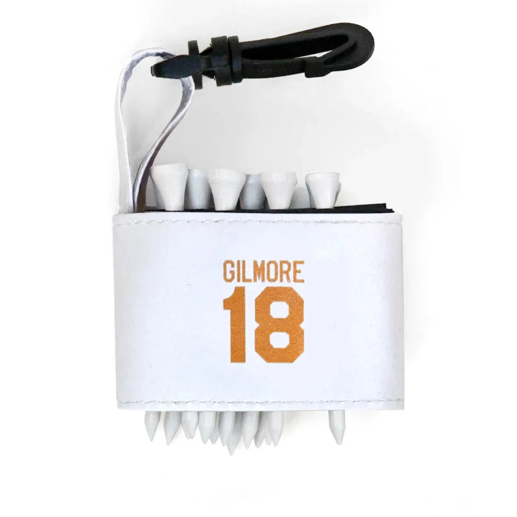 Golf tee holder with 'GILMORE 18' text on a white background