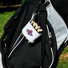 Black golf bag with a white container featuring a logo and text, attached to it.